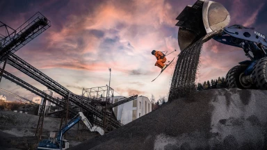 Swiss Freeride Skier Sybille Blanjean jumps out of an excavator shovel