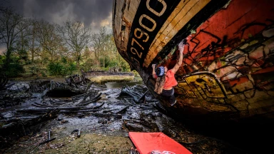 French rock climber Marie Gamen bouldering on a shipwreck